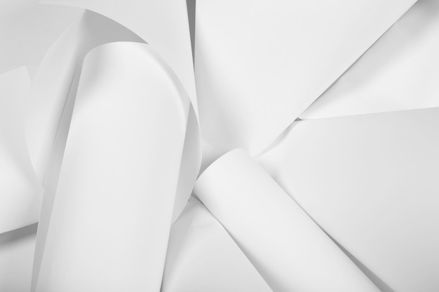 White sheets of office paper are twisted and scattered Paper white abstract background