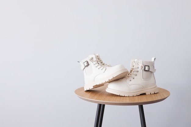 White shoes on a white background with place for text. Fall and winter trends.