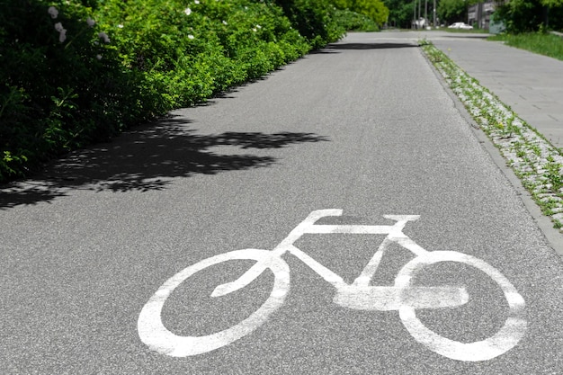 white sign on the pavement for the passage of cyclists bike path