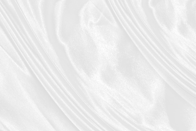 White silk textured cloth backgroundCloseup of rippled satin fabric with soft waves