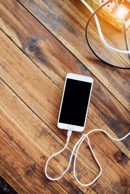 White smartphone on wooden table