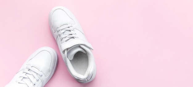 White sneakers on a pink background