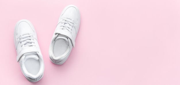 White sneakers on a pink background