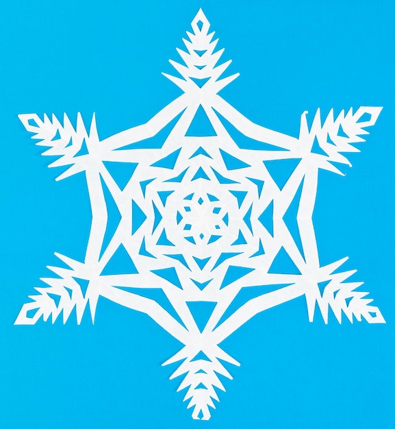 White snowflake on blue paper