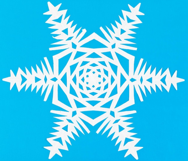 White snowflake on blue paper