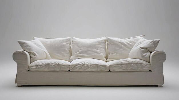 Photo white sofa with four white pillows against a white backdrop