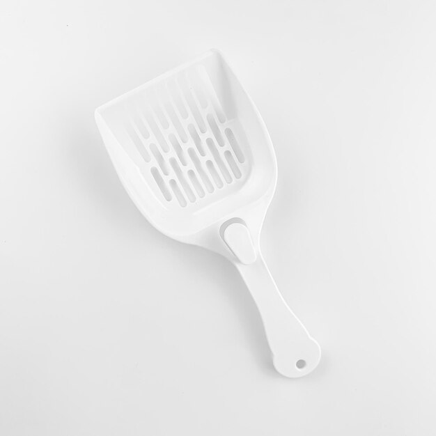 white spatula for pet tray photo on a white background. for advertising and banners