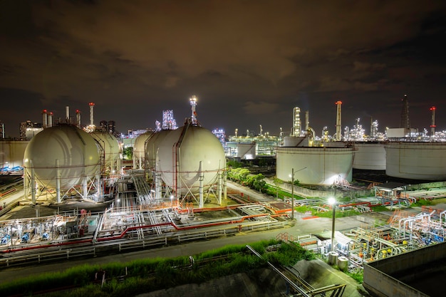 White spherical propane tanks and tank oil at the night containing fuel gas tank pipeline.