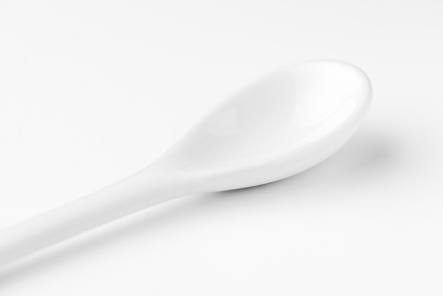 White spoon isolated on a white surface