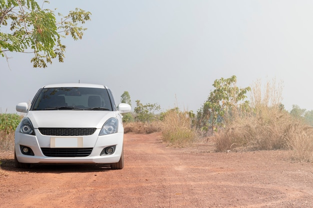 White sports car on dirt road