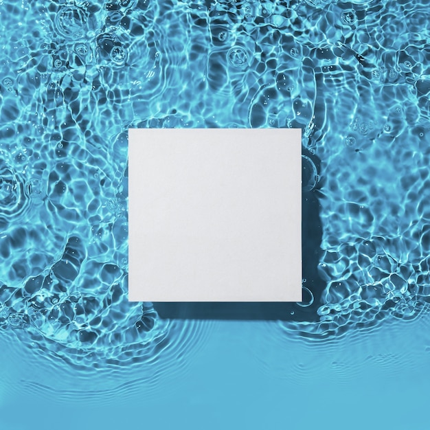 White square podium on the blue water surface background Flat lay copy space