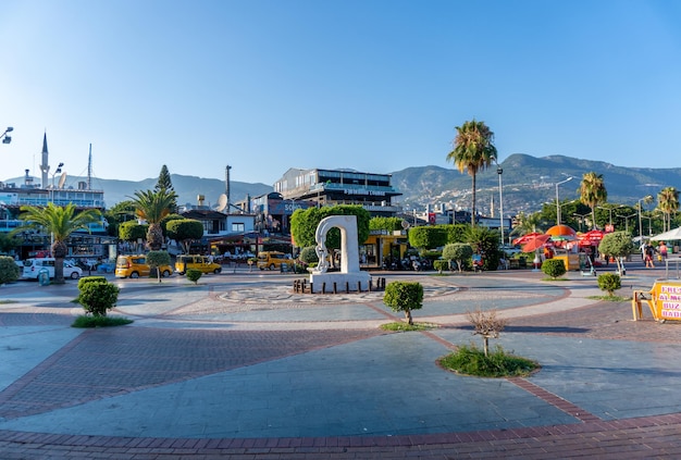 White stone sculpture with a chain on the tourist embankment on the Alanya Marina Exotic tropical