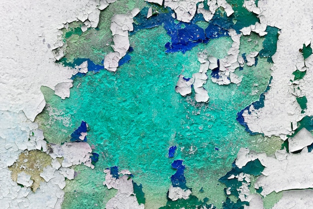 White stone surface with cracked blue and green paint background texture