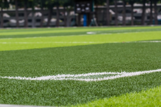 White stripe on the green soccer field from top view