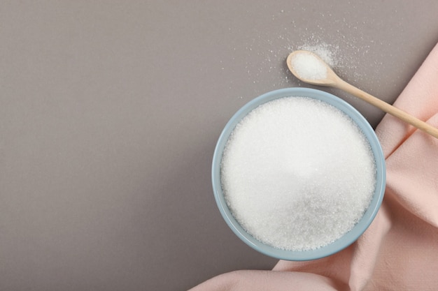 White sugar on the table on a light background closeup