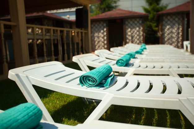 White summer sun beds by the pool in summer