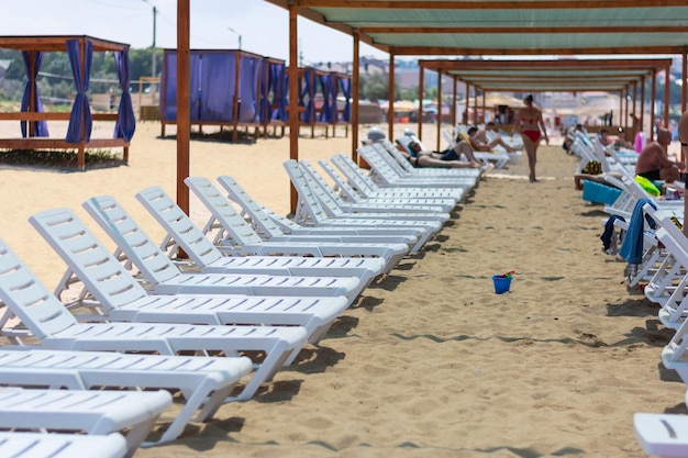 White sun loungers on the beach in summer on vacation