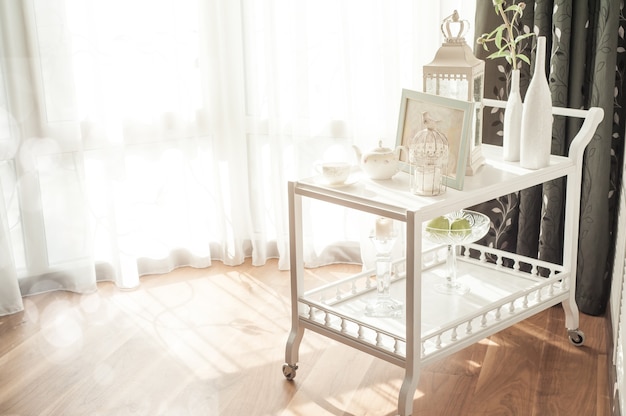 White sunlit interior with serving table and teapot