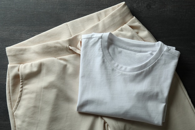 White t-shirt and sweatpants on dark wooden