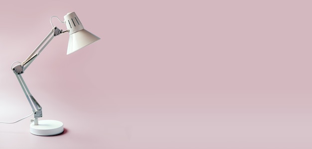 White table lamp isolated on pink background