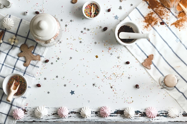 White table with candy powder and various holiday sweets around the center