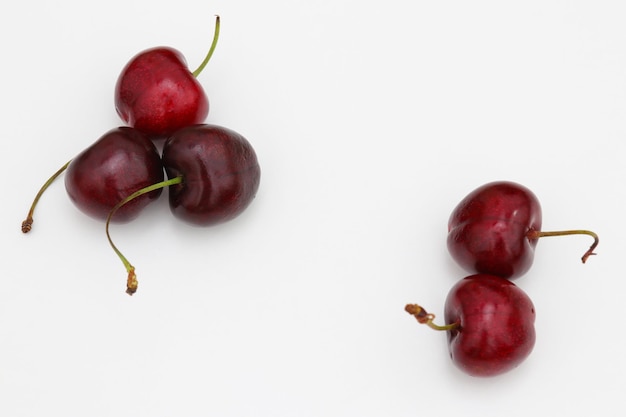 A white table with cherries on it