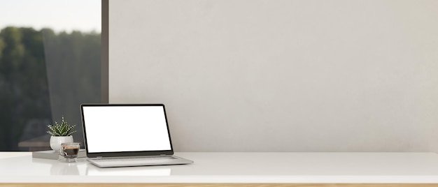 White tabletop workspace with notebook laptop mockup and copy space over white wall