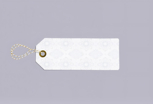 Photo white tag with gold string and delicate floral pattern