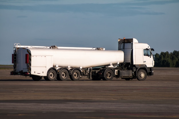 White tank truck aircraft refueler at the airport apron