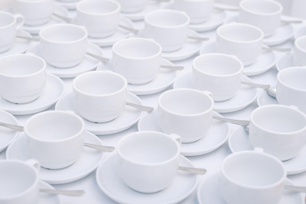 White tea cups with saucer standing on the table..