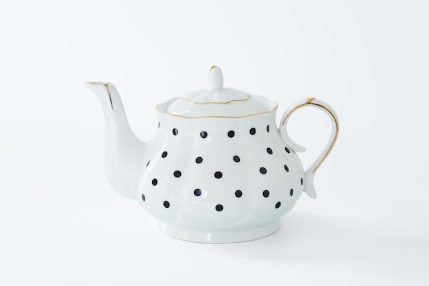 Photo white teapot with black dot design isolated on white background