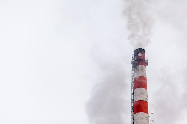 White thick smoke from the boiler room chimney Industrial zone