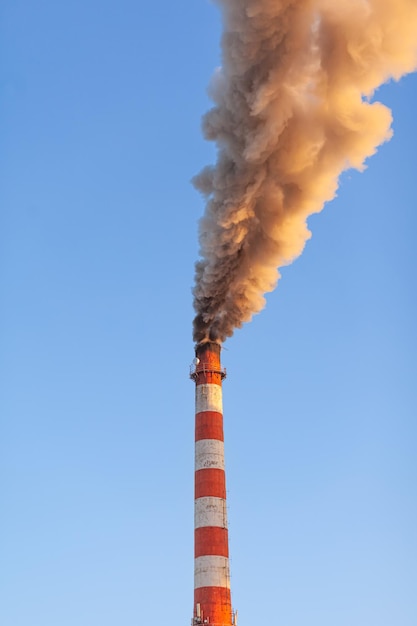 White thick smoke from the boiler room chimney Industrial zone