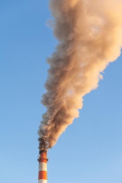 White thick smoke from the boiler room chimney Industrial zone