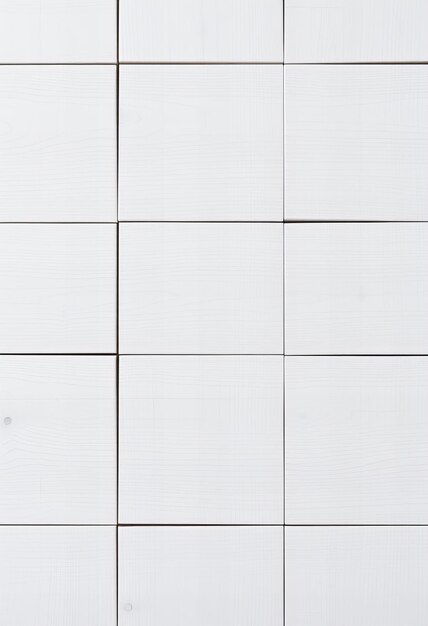 Photo a white tile wall with a small hole in it