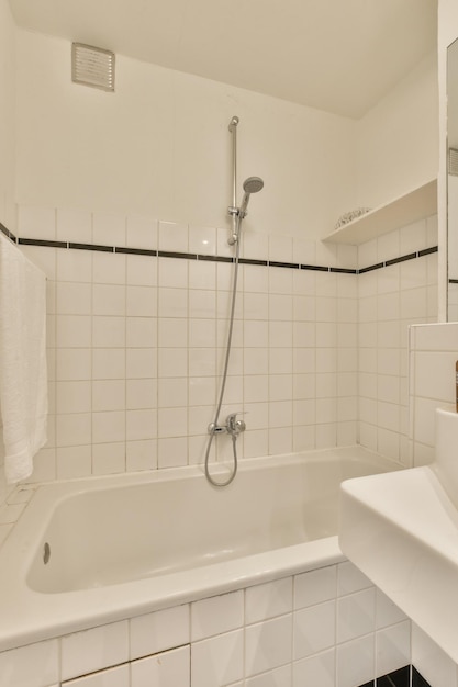 A white tiled bathroom with a shower in it