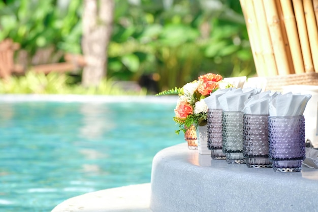 White tissue paper with tissue box near the swimming pool in restaurant at breakfast time and nature blure background