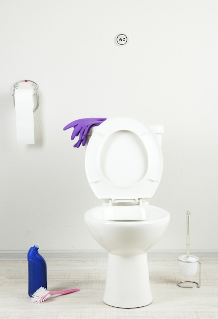 White toilet bowl and cleaner bottle in a bathroom