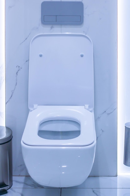 White toilet and metal bin