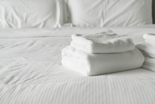 White towel on bed decoration in bedroom interior 