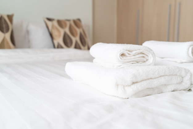 white towel decoration on bed 