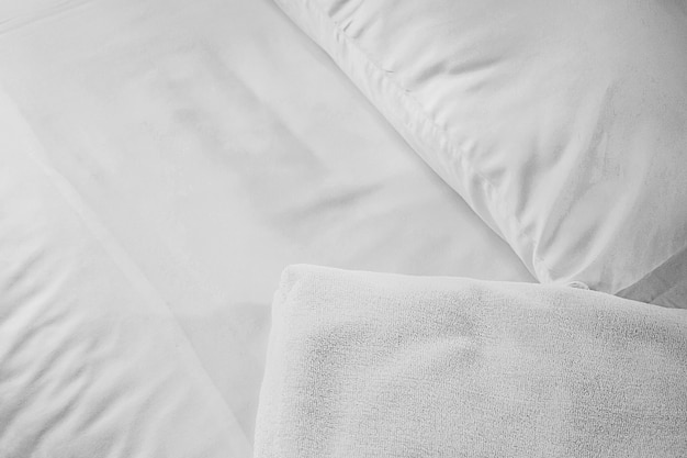 White towel on white mattress fabric, soft light in the morning. Background