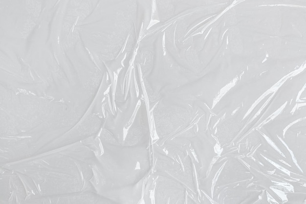 White transparent crumpled and creased plastic poster texture background wet plastic wrap on the white background