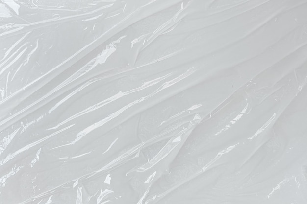 White transparent crumpled and creased plastic poster texture background wet plastic wrap on the white background