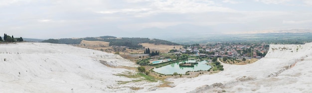 White travertine terraces, a swimming pool with clean hot water from thermal springs in Pamukkale, Denizli province in southwestern Turkey.