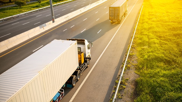 White truck on highway road with container with beautiful sunlight