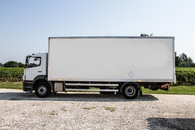 White truck in profile, copy space and countryside background