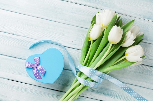 White tulips and heart shaped gift box