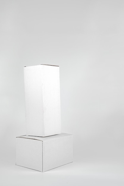 White two paper boxes tall and fat lay on the white background in studio shot with clipping paht