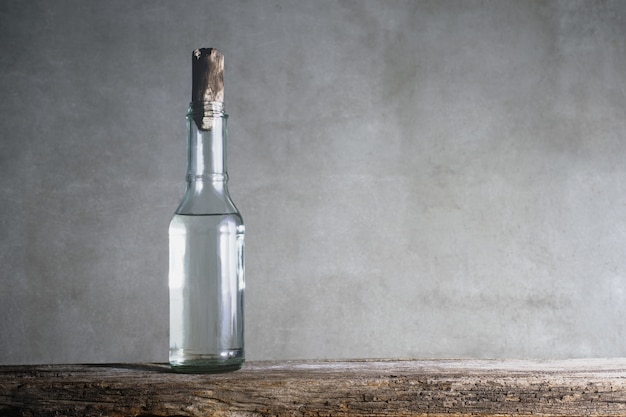 White vinegar bottle on wood table.